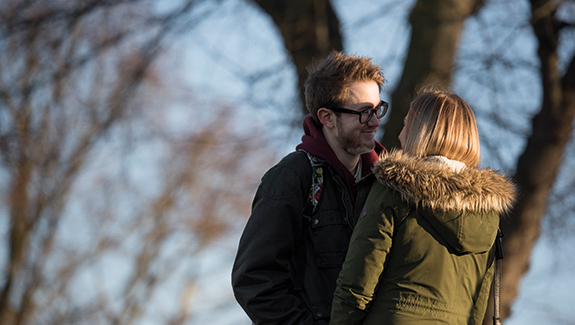 man-observing-stoma-pouch-on-his-abdomen-thinking-about-body-image-concerns-with-a-stoma