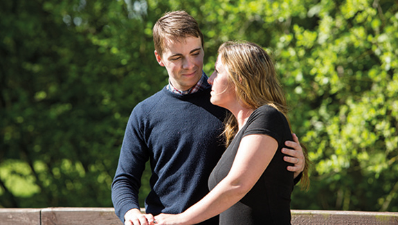 man-observing-stoma-pouch-on-his-abdomen-thinking-about-body-image-concerns-with-a-stoma